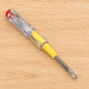 Lakri ke background par tester screwdriver